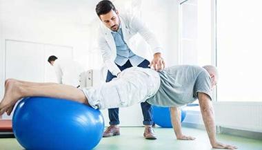 Senior man in physical therapy for back pain